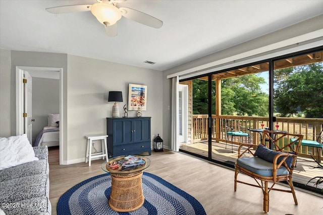 816 Colony Pl Unit D, Sunset Beach, NC 28468 - living area featuring wood finished floors, a ceiling fan, and baseboards