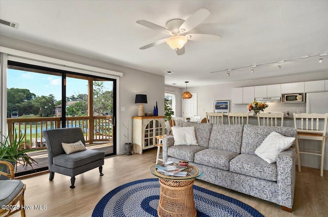 816 Colony Pl Unit D, Sunset Beach, NC 28468 - living room featuring light wood-style floors and ceiling fan
