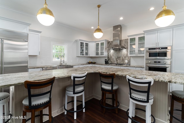 10 Linville Dr, Pinehurst, NC 28374 - kitchen with island range hood, a sink, backsplash, dark wood-style flooring, and white cabinetry