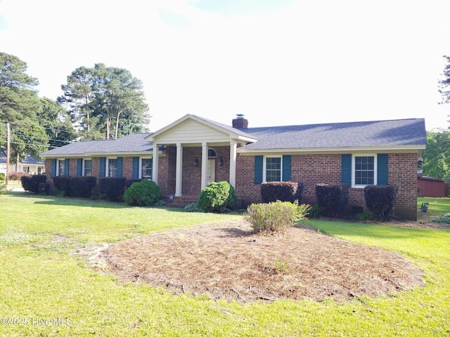 3902 Little John Dr N, Wilson, NC 27896 - ranch-style home featuring brick siding, a front yard, and a chimney