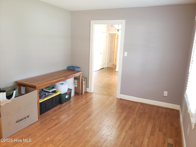 3902 Little John Dr N, Wilson, NC 27896 - empty room with light wood finished floors, baseboards, and a chandelier
