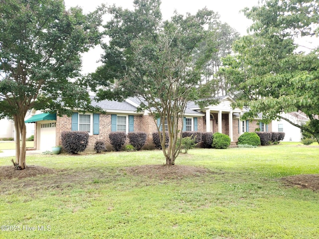 3902 Little John Dr N, Wilson, NC 27896 - view of front of house with brick siding, a garage, and a front yard