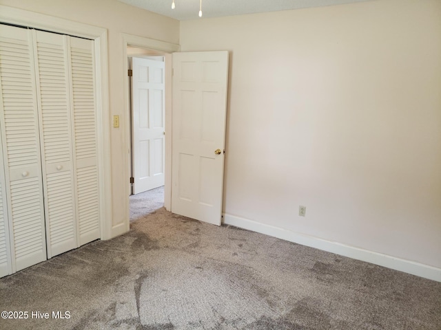 3902 Little John Dr N, Wilson, NC 27896 - unfurnished bedroom featuring carpet, a closet, and baseboards