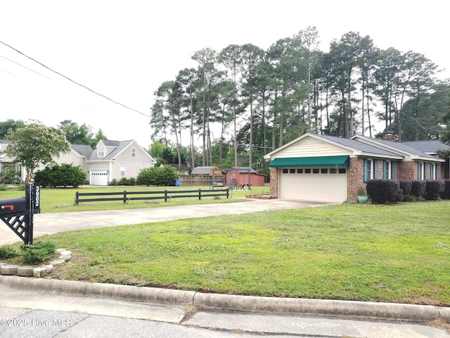 3902 Little John Dr N, Wilson, NC 27896 - view of front of home with driveway, a garage, and brick siding