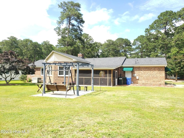 3902 Little John Dr N, Wilson, NC 27896 - back of property with a pergola, a patio area, brick siding, a sunroom, and a lawn