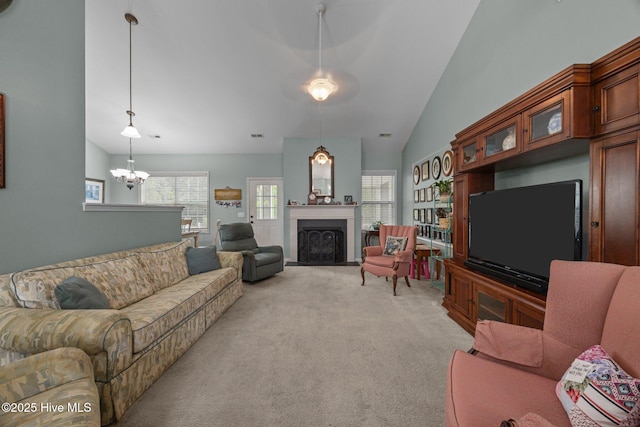 120 Leyland Way, Hampstead, NC 28443 - living room with a chandelier, light colored carpet, vaulted ceiling, and a fireplace with flush hearth