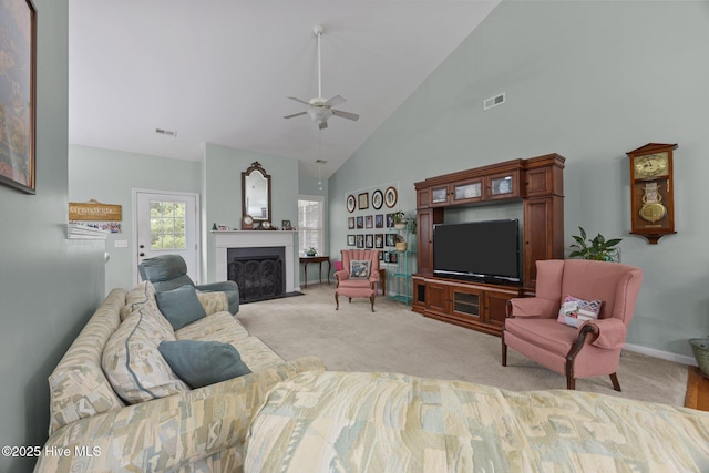 120 Leyland Way, Hampstead, NC 28443 - living area featuring high vaulted ceiling, ceiling fan, light colored carpet, a fireplace with flush hearth, and baseboards