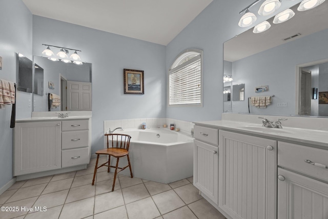 120 Leyland Way, Hampstead, NC 28443 - full bathroom with two vanities, tile patterned floors, a garden tub, and vaulted ceiling
