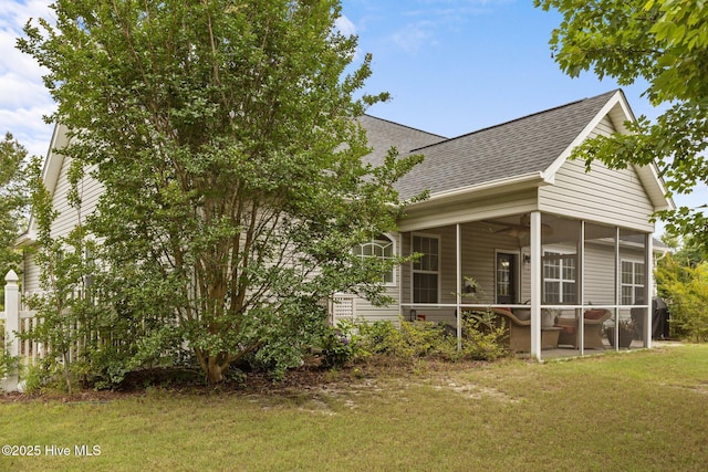 120 Leyland Way, Hampstead, NC 28443 - back of house featuring roof with shingles, a sunroom, and a lawn