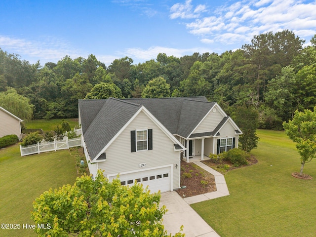 120 Leyland Way, Hampstead, NC 28443 - traditional-style house with an attached garage, driveway, and a wooded view