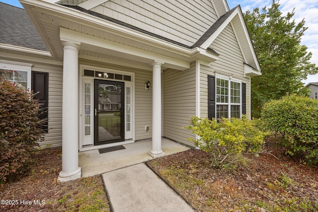 120 Leyland Way, Hampstead, NC 28443 - doorway to property with covered porch and a shingled roof