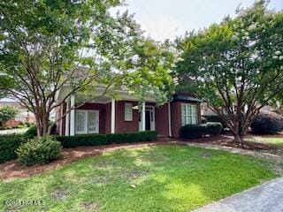 1501 W Morning Dove Ct, Wilmington, NC 28403 - view of property hidden behind natural elements with a front yard