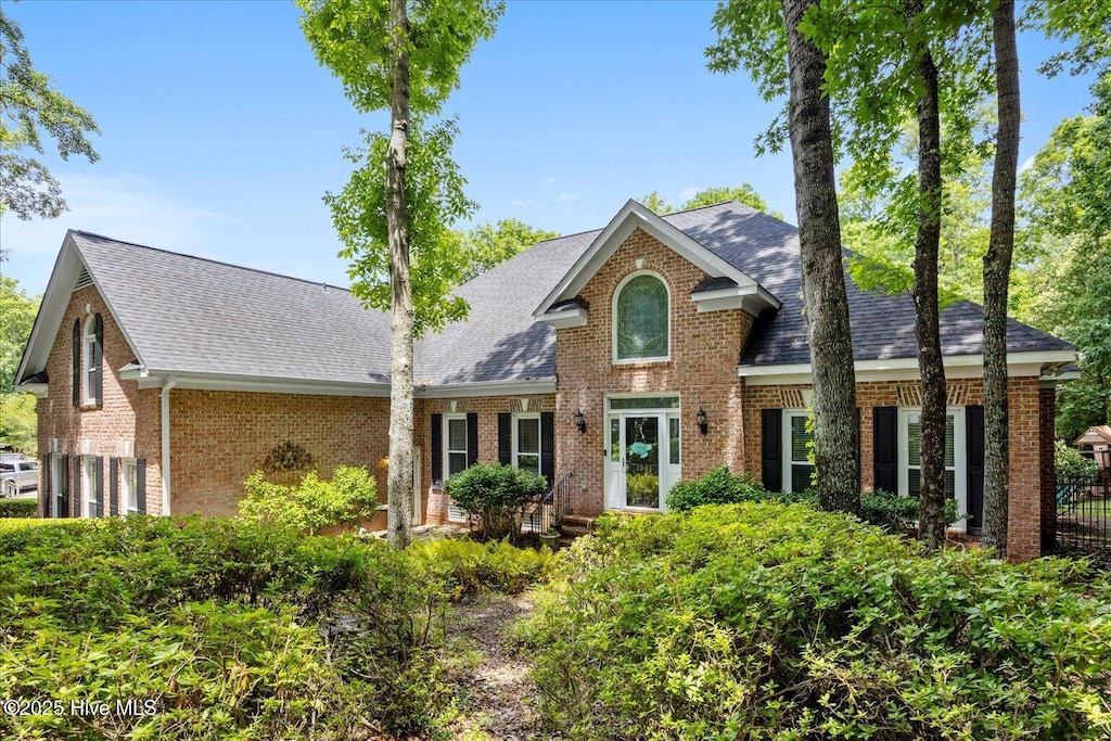 1501 Meridian Ter, Wilmington, NC 28411 - view of front of home with brick siding, roof with shingles, and a garage