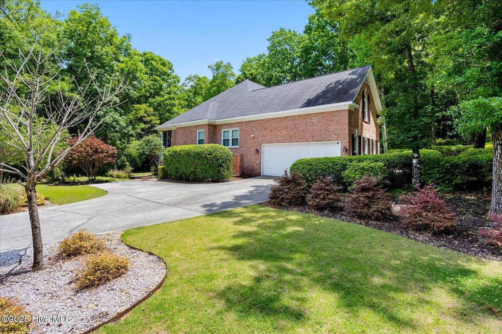 1501 Meridian Ter, Wilmington, NC 28411 - view of front of home with brick siding, concrete driveway, and a front lawn