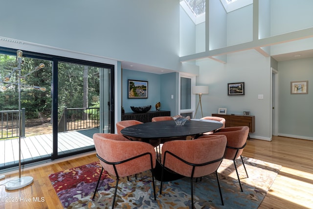 185 Ponte Vedra Dr, Pinehurst, NC 28374 - dining space featuring a skylight, a high ceiling, and wood finished floors