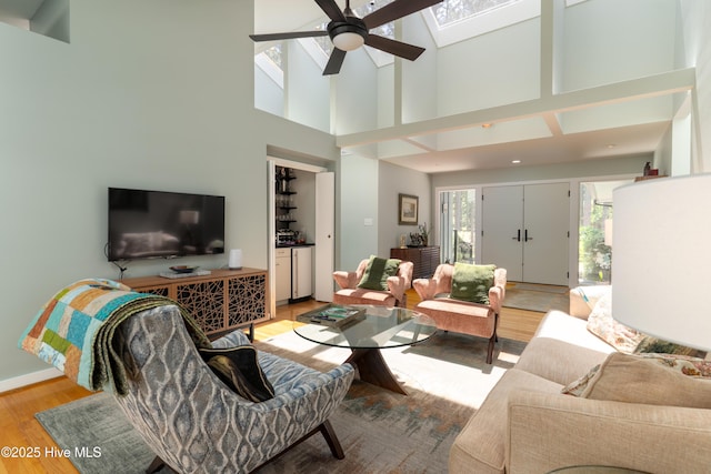 185 Ponte Vedra Dr, Pinehurst, NC 28374 - living room with ceiling fan, a high ceiling, a skylight, and light wood-style flooring
