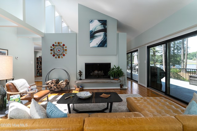 185 Ponte Vedra Dr, Pinehurst, NC 28374 - living area featuring wood finished floors, a fireplace with raised hearth, and a towering ceiling
