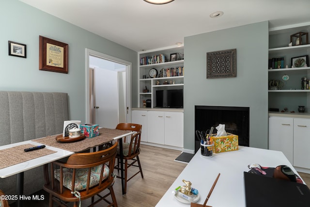 185 Ponte Vedra Dr, Pinehurst, NC 28374 - dining area with light wood-type flooring, a fireplace, and built in shelves