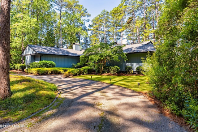 185 Ponte Vedra Dr, Pinehurst, NC 28374 - view of front of house with asphalt driveway, a front yard, and a chimney