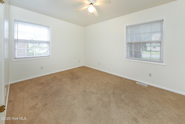 1710 Aydlett Cir, Elizabeth City, NC 27909 - spare room featuring carpet floors, healthy amount of natural light, ceiling fan, and baseboards