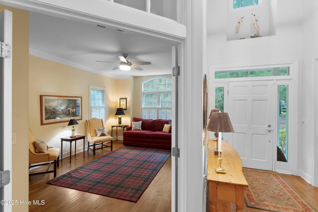 1012 Creekside Ln, Wilmington, NC 28411 - foyer featuring wood finished floors, ceiling fan, ornamental molding, baseboards, and a high ceiling