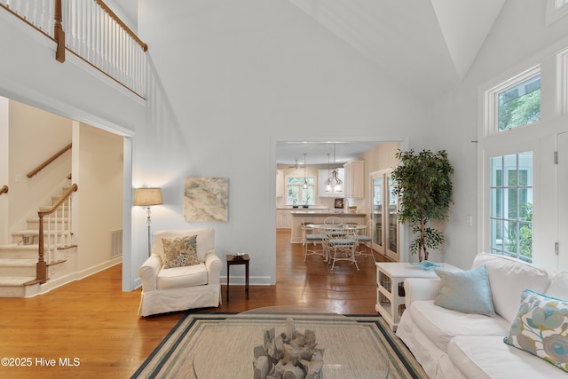 1012 Creekside Ln, Wilmington, NC 28411 - living room with high vaulted ceiling, light wood-style flooring, stairway, healthy amount of natural light, and baseboards