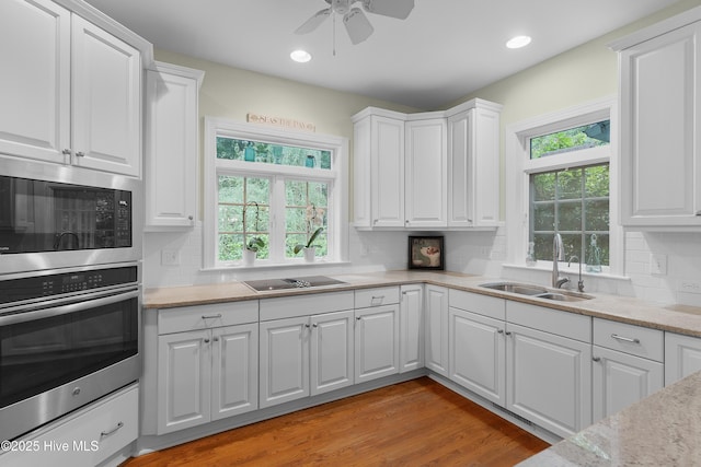 1012 Creekside Ln, Wilmington, NC 28411 - kitchen featuring oven, a sink, built in microwave, plenty of natural light, and recessed lighting