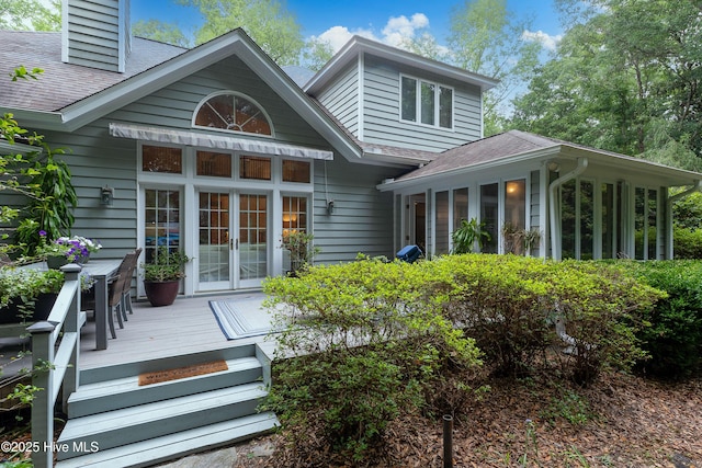 1012 Creekside Ln, Wilmington, NC 28411 - back of property featuring a sunroom, a shingled roof, french doors, a deck, and a chimney
