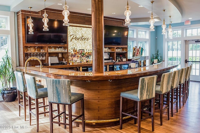 1012 Creekside Ln, Wilmington, NC 28411 - indoor wet bar with wood finished floors and hanging light fixtures