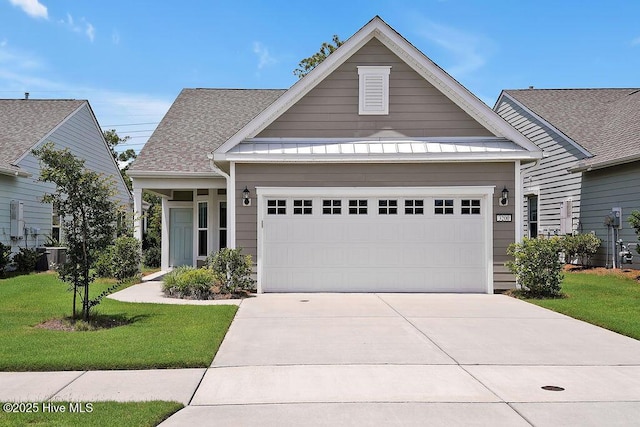 3200 Laughing Gull Ter, Wilmington, NC 28412 - view of front of home with driveway, a front lawn, and a garage