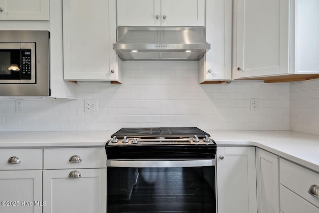 3200 Laughing Gull Ter, Wilmington, NC 28412 - kitchen with appliances with stainless steel finishes, wall chimney range hood, white cabinets, and light countertops