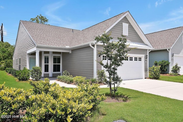 3200 Laughing Gull Ter, Wilmington, NC 28412 - view of front of house featuring a shingled roof, driveway, an attached garage, and a front yard