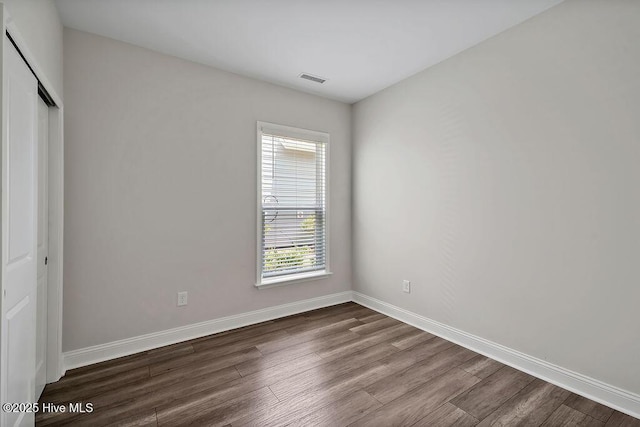 3200 Laughing Gull Ter, Wilmington, NC 28412 - unfurnished bedroom featuring dark wood finished floors and a closet