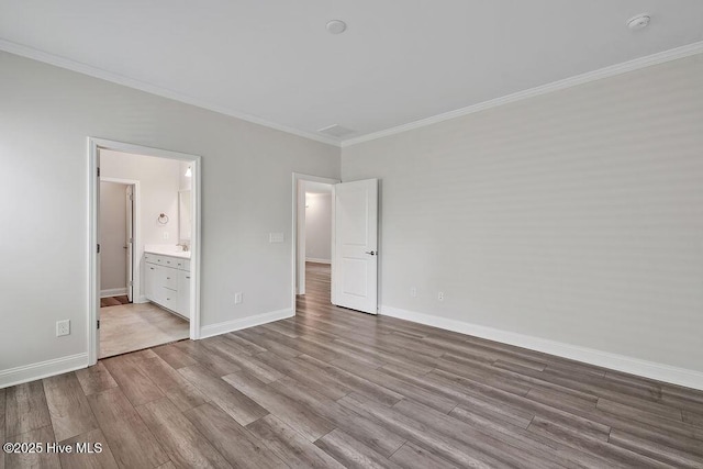 3200 Laughing Gull Ter, Wilmington, NC 28412 - unfurnished bedroom featuring wood finished floors, crown molding, and connected bathroom
