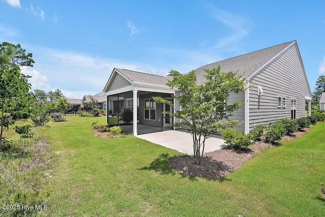 3200 Laughing Gull Ter, Wilmington, NC 28412 - back of house featuring a patio, a yard, a sunroom, and roof with shingles