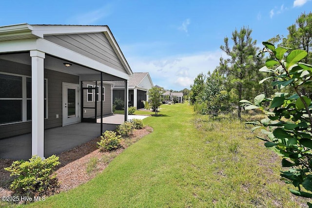 3200 Laughing Gull Ter, Wilmington, NC 28412 - view of grassy yard with a patio area and a sunroom