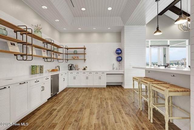 3200 Laughing Gull Ter, Wilmington, NC 28412 - kitchen with open shelves, wood ceiling, light wood-style flooring, white cabinetry, and light countertops