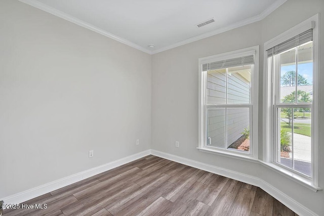 3200 Laughing Gull Ter, Wilmington, NC 28412 - empty room featuring dark wood-type flooring, healthy amount of natural light, and ornamental molding