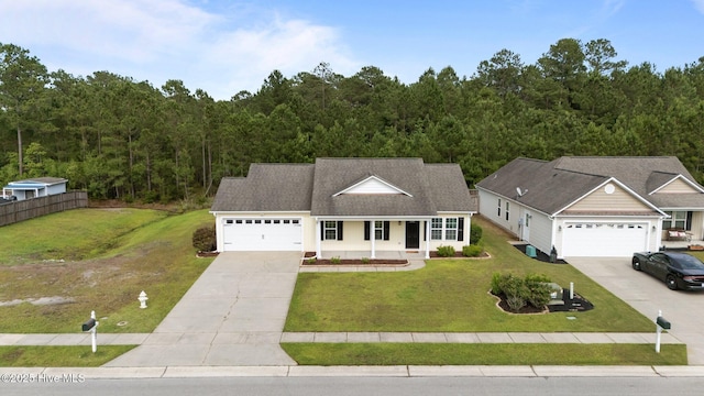 182 Tylers Cove Way, Winnabow, NC 28479 - traditional-style house featuring driveway, an attached garage, a wooded view, and a porch
