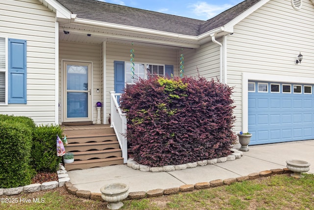 600 Pearson Cir, Newport, NC 28570 - view of exterior entry featuring a garage, a shingled roof, and a porch