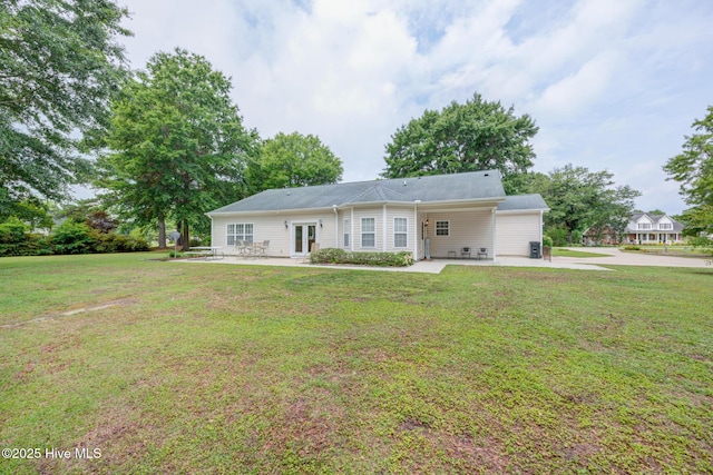 318 Winding Creek Rd, Rocky Point, NC 28457 - view of front of property with a patio area, french doors, a front yard, and an attached carport