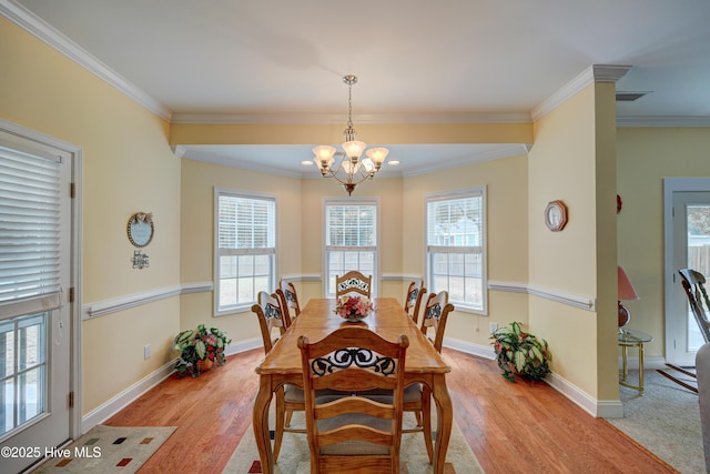318 Winding Creek Rd, Rocky Point, NC 28457 - dining space with a chandelier, light wood finished floors, plenty of natural light, and ornamental molding