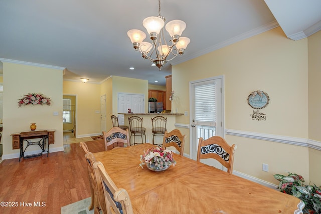 318 Winding Creek Rd, Rocky Point, NC 28457 - dining area featuring a chandelier, crown molding, light wood-type flooring, and baseboards