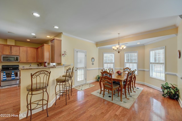 318 Winding Creek Rd, Rocky Point, NC 28457 - dining room with a chandelier, light wood finished floors, crown molding, baseboards, and recessed lighting