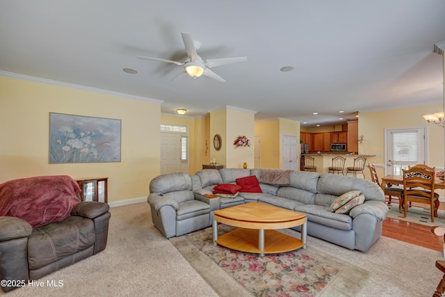 318 Winding Creek Rd, Rocky Point, NC 28457 - living area with crown molding, a chandelier, healthy amount of natural light, ceiling fan, and baseboards
