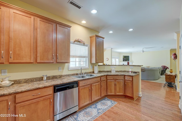 318 Winding Creek Rd, Rocky Point, NC 28457 - kitchen featuring stainless steel dishwasher, a sink, a peninsula, open floor plan, and light wood-type flooring