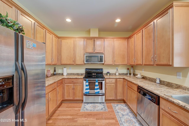 318 Winding Creek Rd, Rocky Point, NC 28457 - kitchen featuring stainless steel appliances, light wood-style floors, light brown cabinetry, recessed lighting, and light stone countertops