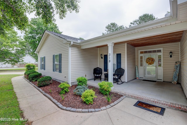 318 Winding Creek Rd, Rocky Point, NC 28457 - view of exterior entry with a porch