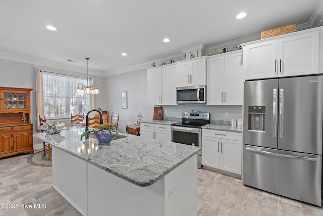 2402 W Oak Island Dr, Oak Island, NC 28465 - kitchen with appliances with stainless steel finishes, ornamental molding, a chandelier, white cabinets, and recessed lighting