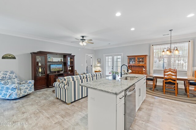 2402 W Oak Island Dr, Oak Island, NC 28465 - kitchen with a sink, stainless steel dishwasher, a center island with sink, ornamental molding, and a chandelier